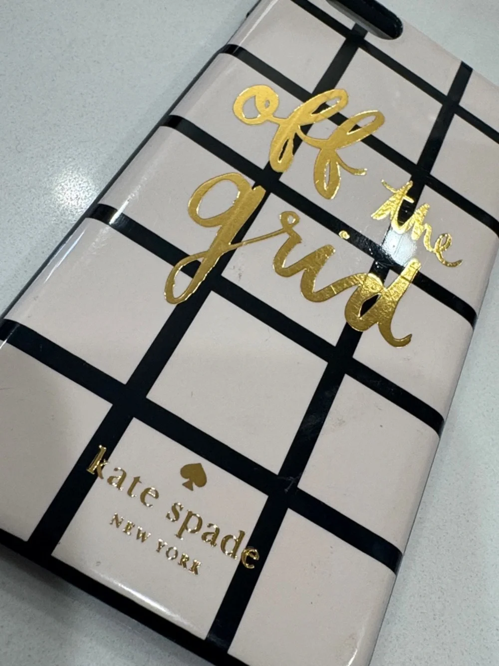 kate spade cream phone case with black grid and gold foil script